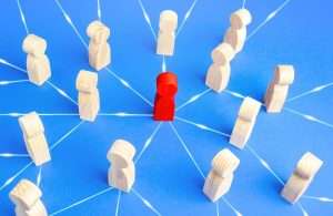 interconnected peg people with red peg representing radiology leader