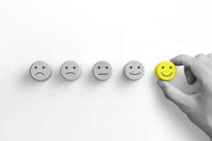 wooden peg with different face emotions, patient satisfaction survey concept