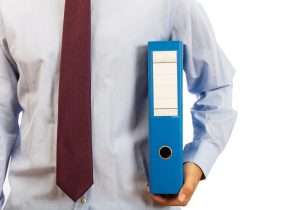 business man holding binder in preparation for ppp and prf reporting and audits