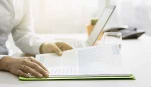 Businesswoman checking MIPS reports and statements