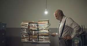 radiology biller with piles of papers, technology concept